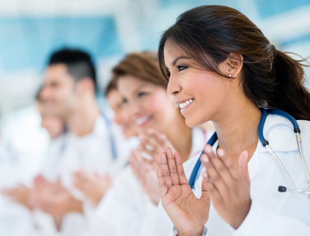 Successful group of doctors applauding at the hospital 